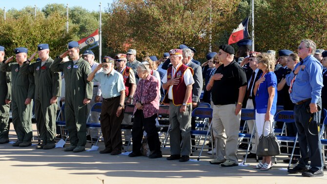 Team Beale and former Prisoners of War salute during a POW/MIA roll call at Heritage Park on Beale Air Force Base, Calif., Sept. 20, 2013. The U.S. National POW/MIA Recognition Day is observed the third Friday of September. (U.S. Air Force photo by Staff Sgt. Robert M. Trujillo/Released)
