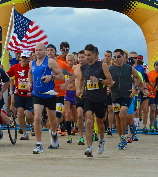 Runners at the Barksdale Half Marathon cross the starting line on Barksdale Air Force Base, La., Sept. 21, 2013. The 13.1 mile course started on the flightline, continued through base housing and ended back on the flightline. (U.S. Air Force photo/Senior Airman Micaiah Anthony)