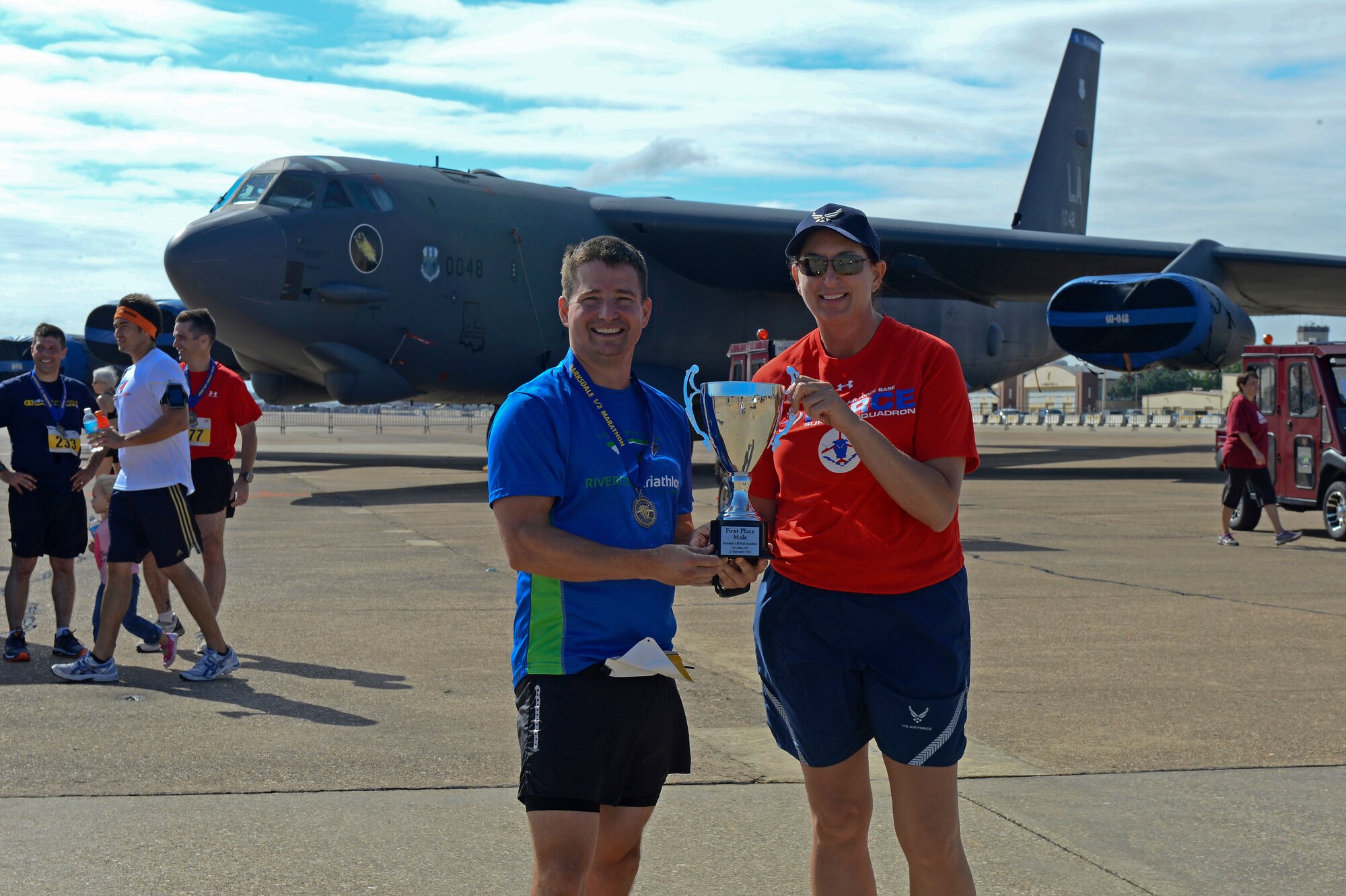 Lt. Col. Diane Benavidez, right, 2nd Force Support Squadron commander, poses for a photo with Lt. Col. Charles McElvaine, 2nd Operations Support Squadron commander, after the Barksdale Half Marathon and 5k on Barksdale Air Force Base, La., Sept. 21, 2013. McElvaine took first place overall for the half marathon with a time of 1:25:07. (U.S. Air Force photo/Senior Airman Micaiah Anthony)
