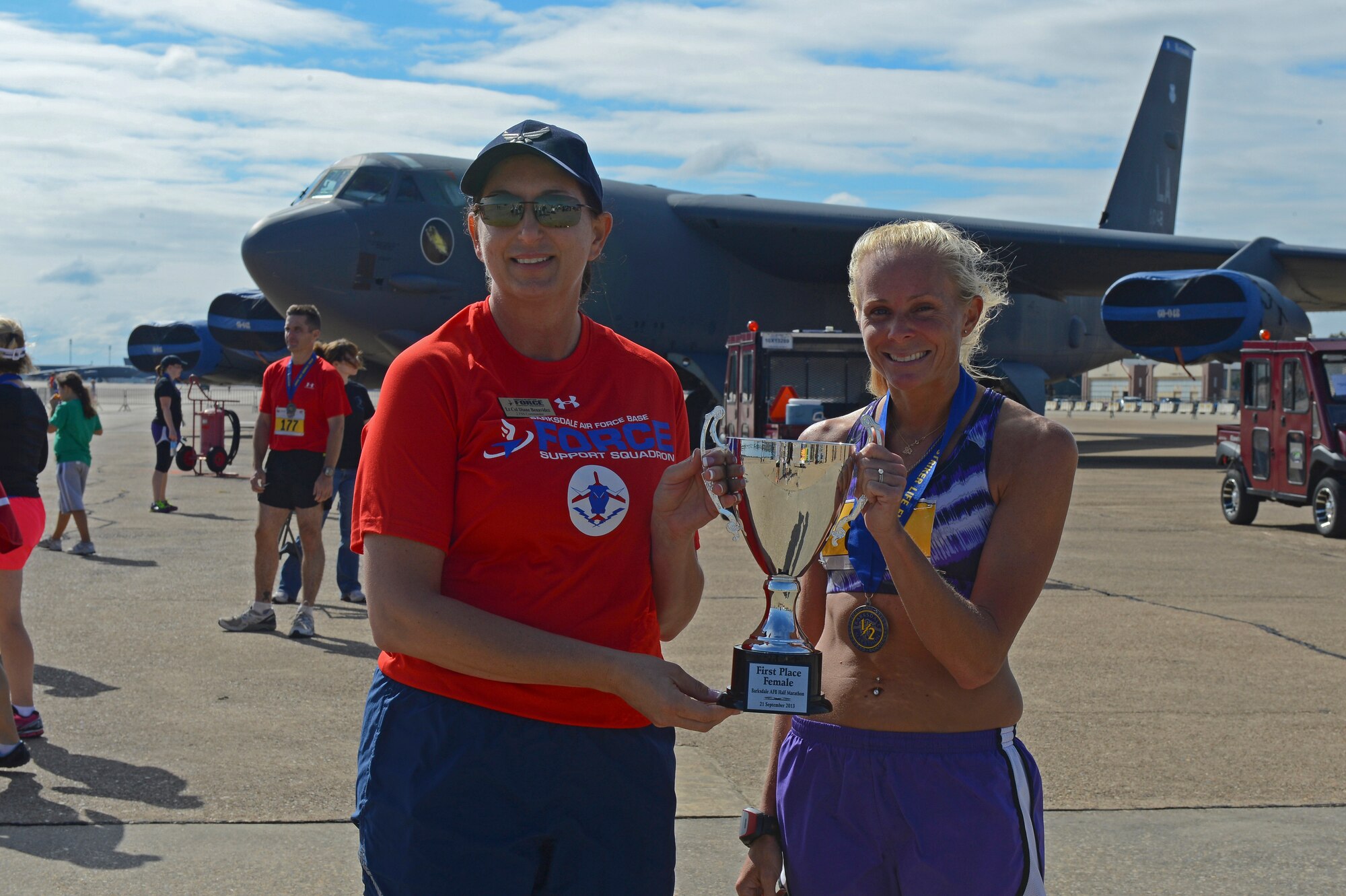 Lt. Col. Diane Benavidez, left, 2nd Force Support Squadron commander, poses for a photo with Angela Garcia after the Barksdale Half Marathon and 5k on Barksdale Air Force Base, La., Sept. 21, 2013. Garcia took first place in the half marathon's female category with a time of 1:41:08. (U.S. Air Force photo/Senior Airman Micaiah Anthony)
