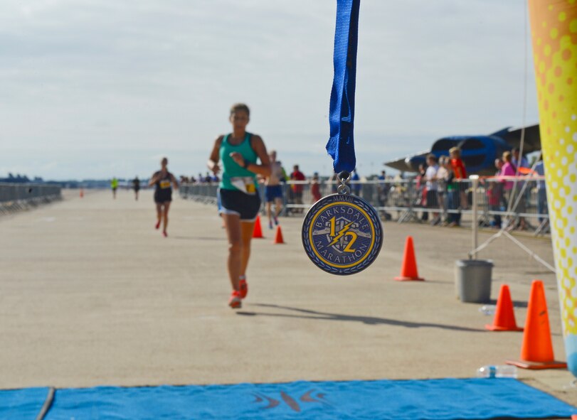 Participants of the Barksdale Half Marathon run for the finish line on Barksdale Air Force Base, La., Sept. 21, 2013. Runners wore running chips to track their time as they crossed the finish line. The fastest time for the half marathon was set by Lt. Col. Charles McElvaine, 2nd Operations Support Squadron commander, with a time of 1:25:07. (U.S. Air Force photo/Senior Airman Micaiah Anthony)