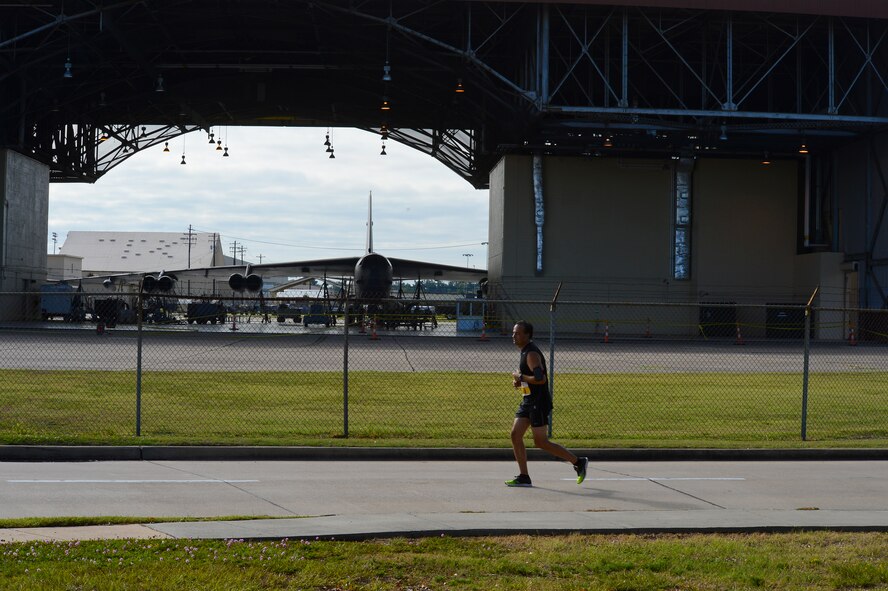 A participant of the Barksdale Half Marathon runs past a hangar on Barksdale Air Force Base, La., Sept. 21, 2013. Along with the half marathon, Barksdale also hosted a 5k for its members and the local community to participate in. (U.S. Air Force photo/Senior Airman Micaiah Anthony)
