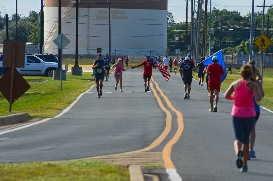 Runners exchange a high-five during the Barksdale Half Marathon on Barksdale Air Force Base, La., Sept. 21, 2013. The marathon was open this year to members of the local community for the first time. (U.S. Air Force photo/Senior Airman Micaiah Anthony)