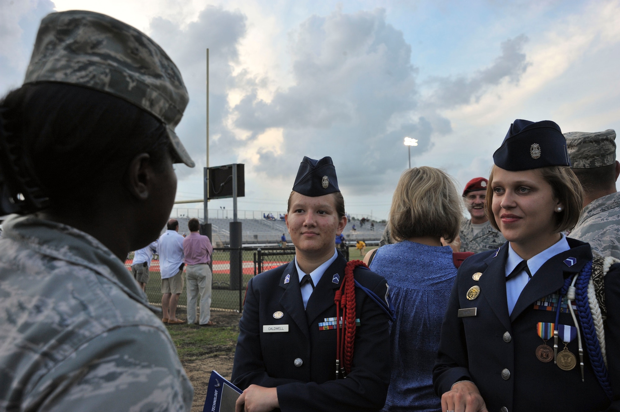 Staff Sgt. Eboni Reams, 1st Special Operations Wing Public Affairs community relations specialist, speaks to Junior ROTC cadets prior to a high school football game in Fort Walton Beach, Fla., Sept. 20, 2013. Fort Walton Beach High School honored two wounded warriors during the football game. (U.S. Air Force photo /Airman 1st Class Andrea Posey)