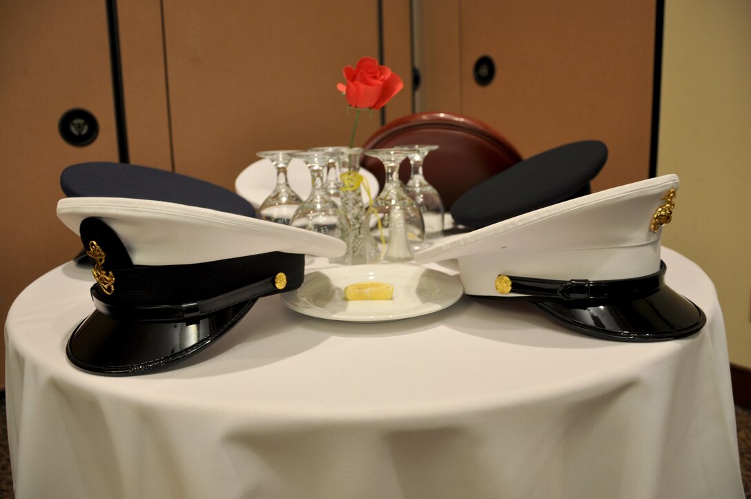 Service caps from all branches of the military rest on a table of honor during a POW/MIA breakfast at the Recce Point Club on Beale Air Force Base, Calif., Sept. 20, 2013. The U.S. National POW/MIA Recognition Day is observed the third Friday of September. (U.S. Air Force photo by Staff Sgt. Robert M. Trujillo/Released)