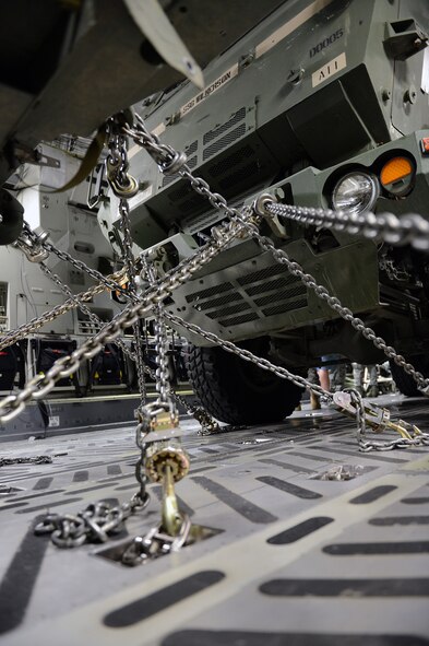 Two M142 High Mobility Artillery Rocket System units sit securely chained inside a C-17 Globemaster III aircraft, Sept. 17, 2013, at Joint Base Lewis-McChord, Wash. Each unit’s chains had to be correctly positioned and tightened in accordance with established standards prior to takeoff. (U.S. Air Force photo/Airman 1st Class Jacob Jimenez)        