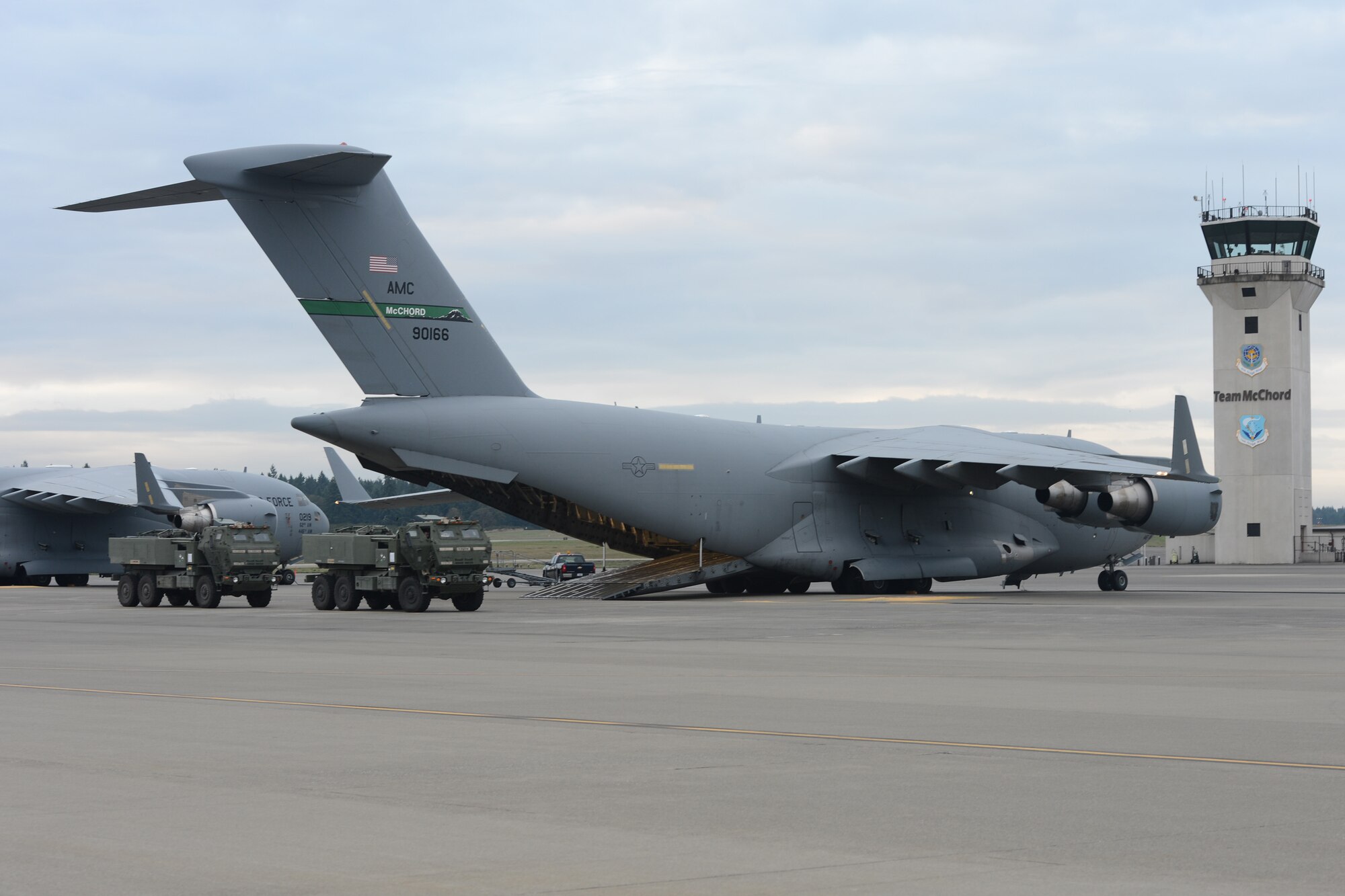 Soldiers from 1st battalion, 94th Field Artillery Regiment, 17th Fires Brigade, wait to load two M142 High Mobility Artillery Rocket Systems onto a C-17 Globemaster III aircraft, Sept. 17, 2013, at Joint Base Lewis-McChord, Wash. Airmen from the 4th Airlift Squadron and Soldiers from the 1-94 FAR transported two HIMARS to Schoonover, Calif., where they performed simulated live fires during a HIMARS Rapid Infiltration (HI-RAIN) exercise. (U.S. Air Force photo/Airman 1st Class Jacob Jimenez) 