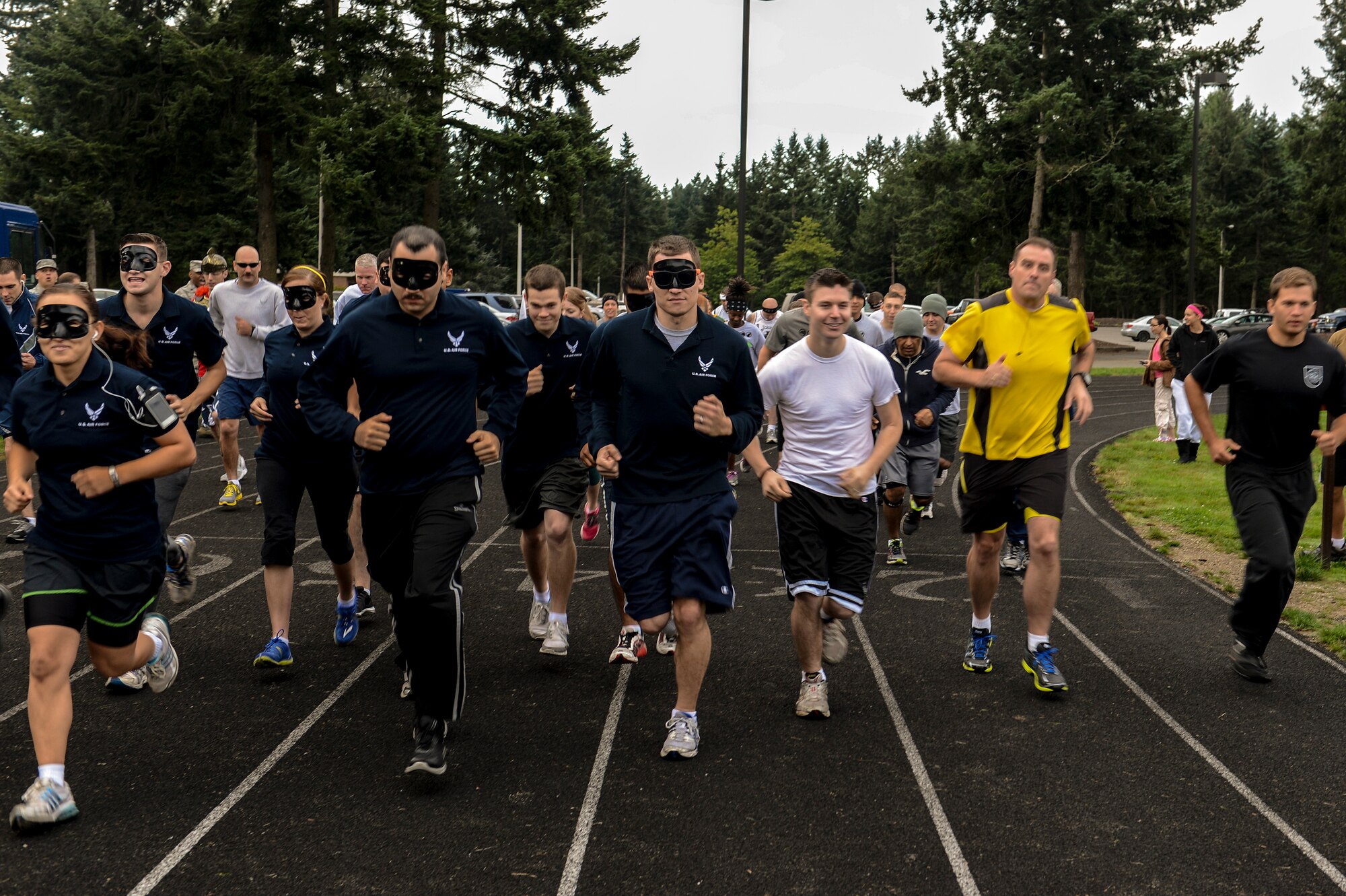 Airmen participating in the 2013 POW/MIA run take off from the starting line, Sept. 18, 2013, at the McChord running track at Joint Base Lewis-McChord, Wash. Various units participated in the 24-hour run, which was organized to honor service members who served as prisoners of war or are missing in action. (U.S. Air Force photo/Tech. Sgt. Sean Tobin)