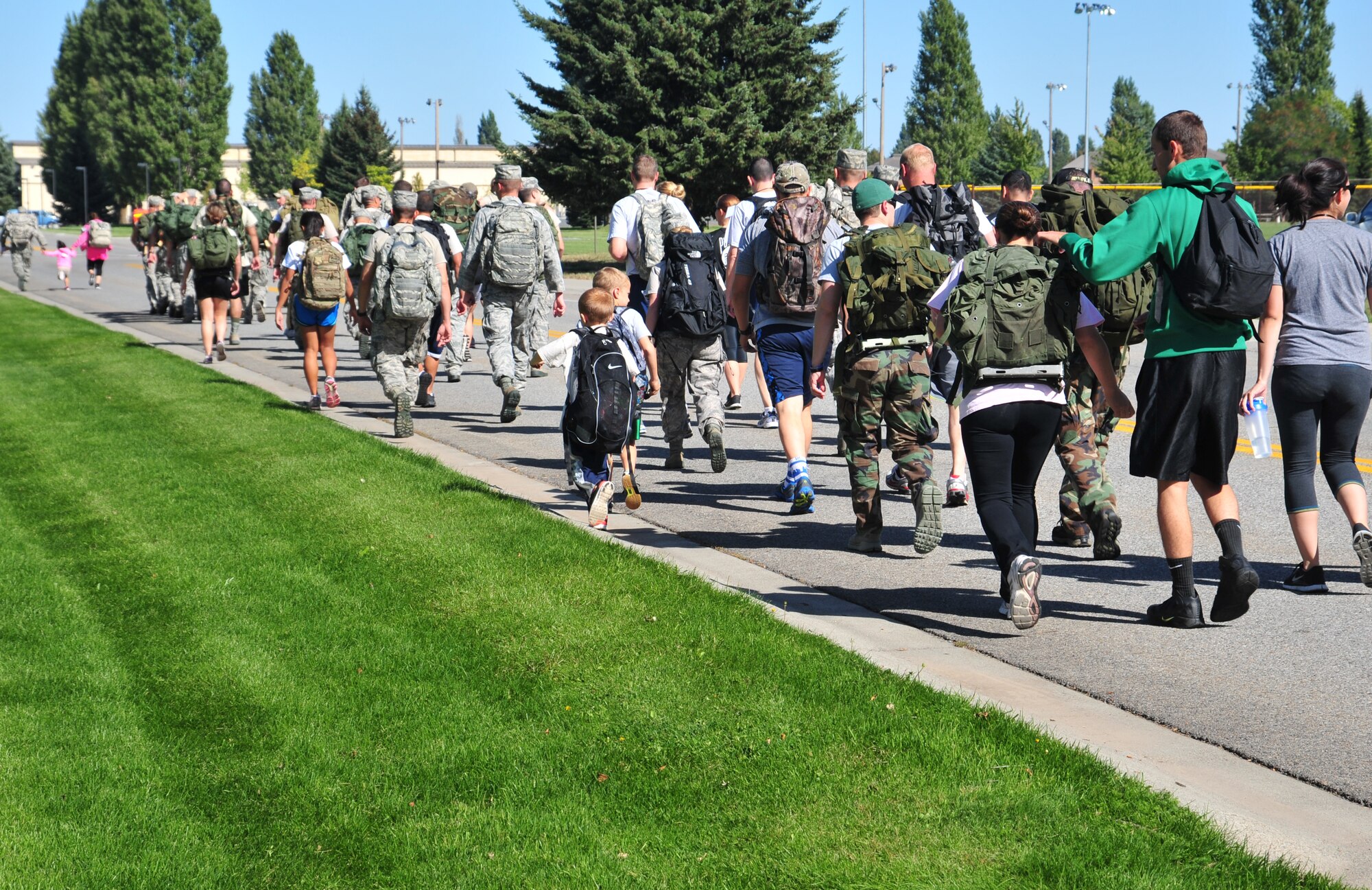 Members of Team Fairchild start the “Ruck for the Missing 5K” in honor of Prisoner of War/Missing in Action Recognition Day at Fairchild Air Force Base, Wash., Sept. 20. Military, civilian and families participated carrying more than 20-pound rucks and raising funds for the Wounded Warrior Project. (U.S. Air Force photo by Staff Sgt. Michael Means/Released)