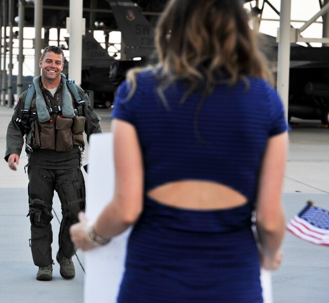 U.S. Air Force Maj. Ben Vickers, an 55th Fighter Squadron F-16 Fighting Falcon pilot  walks down the flight line, Sept 18, 2013, Shaw Air Force Base, S.C.. The 55th FS returned home from the Republic of Korea after being deployed for five months. (U.S. Air Force photo by Airman 1st Class Jonathan Bass/Released) 
