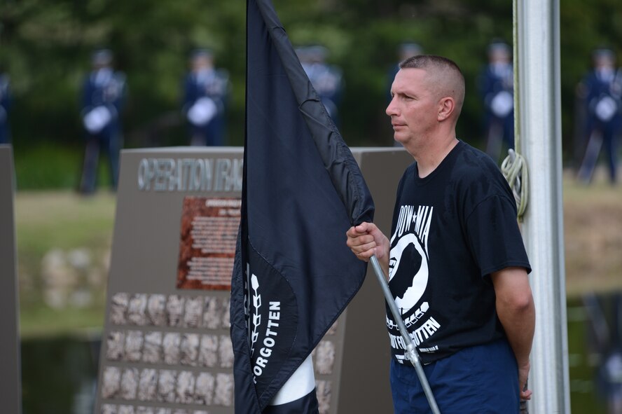 U.S. Air Force Senior Master Sgt. Frank Graziano, 20th Logistic Readiness Squadron superintendent, holds the Prisoners of War and Missing in Action flag during the retreat ceremony at Shaw Air Force Base, S.C., honoring POW/MIA Remembrance day, Sept. 20, 2013. Following the retreat, there was a twenty-one-gun salute by the base honor guard. (U.S. Air Force photo by Airman 1st Class Krystal M. Jeffers/Released)