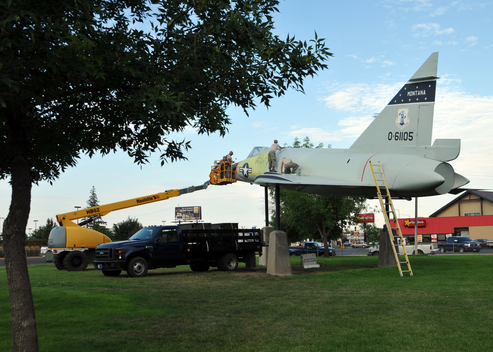 U.S. Airmen of the 120th Fighter Wing, Montana Air National Guard work to restore the exterior of the F-102 Delta Dagger fighter aircraft that serves as a Lions Park static display in Great Falls, Mont. on Sept. 4, 2013. National Guard photo/Senior Master Sgt. Eric Peterson.  