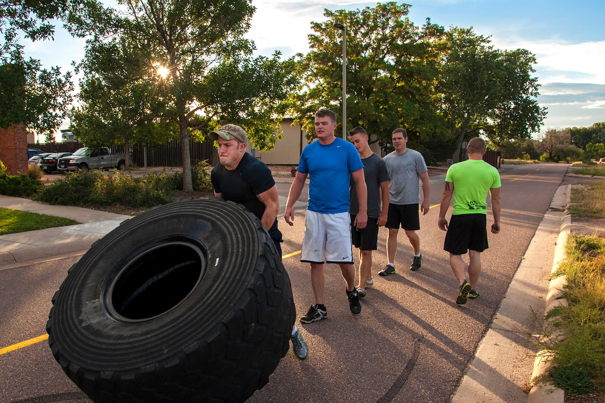 PETERSON AIR FORCE BASE, Colo. – Senior Airman David Hartman, 21st Explosive Ordnance Disposal Flight, flips a 300-pound tire during the flight’s early morning physical training Sept. 18. Senior Airman Robert Powell, Airman 1st Class Nicholas Stewart, Master Sgt. Jeremy Raine, and Senior Airman Terry Smith, also from the 21st EOD Flight, took turns flipping the tire down Duluth Avenue for a total of about a half mile. (U.S. Air Force photo/Craig Denton)