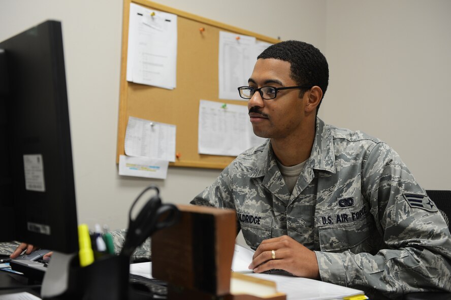 Senior Airman Alexander Aldridge, 20th Logistics Readiness Squadron vehicle operator, sits at his desk as he fulfills administrative duties on his computer at Shaw Air Force Base, S.C., Aug. 23, 2013. Aldridge spent his childhood visiting family and living in North Carolina, Connecticut and Jamaica and hopes to make a career in the Air Force. (U.S. Air Force photo by Airman 1st Class Daniel Blackwell/Released)