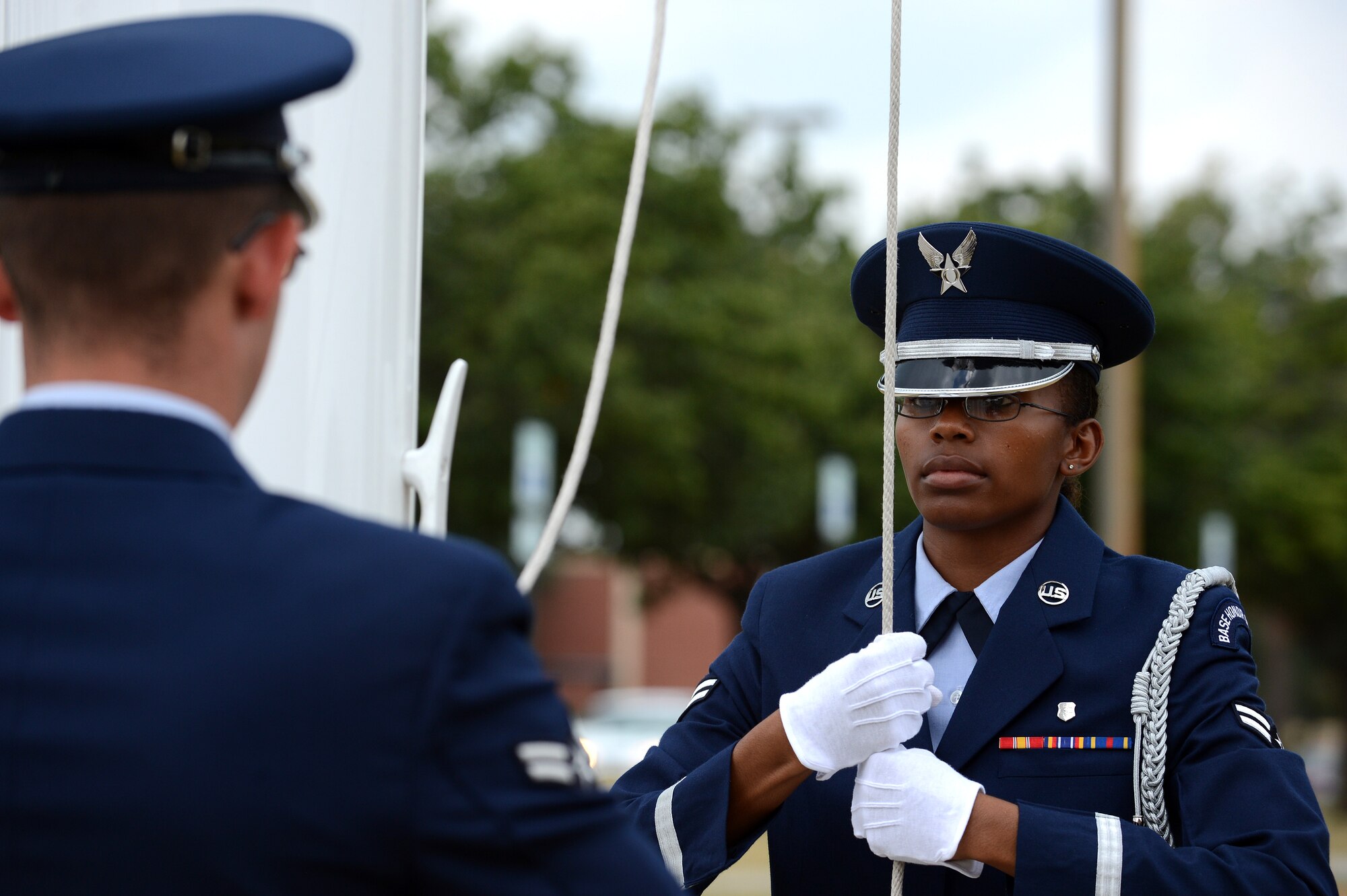 Members of the Shaw Air Force Base Honor Guard prepare to lower the flag during a Prisoners of War and Missing in Action Remembrance Day ceremony at Shaw AFB, S.C., Sept. 20, 2013. The ceremony included a World War II POW guest speaker, as well as a 21-gun salute and a wreath-laying ceremony. (U.S. Air Force photo by Airman 1st Class Daniel Blackwell/Released)