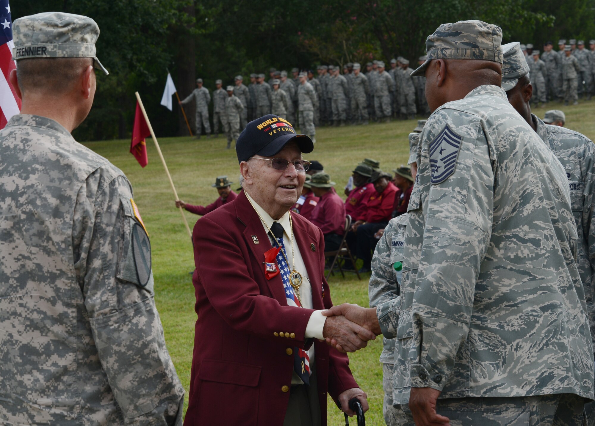 U.S. Air Force Chief Master Sgt. James Wilkerson, 20th Fighter Wing command chief, shakes hands with Thomas Grove, World War II prisoner of war, before the Prisoners of War and those Missing in Action Remembrance Day ceremony at Shaw Air Force Base, S.C., Sept. 20, 2013. The ceremony was held at Memorial Lake in honor of those Americans who have fallen, gone missing and/or become prisoners of war. (U.S. Air Force photo by Senior Airman Tabatha Zarrella/Released)
