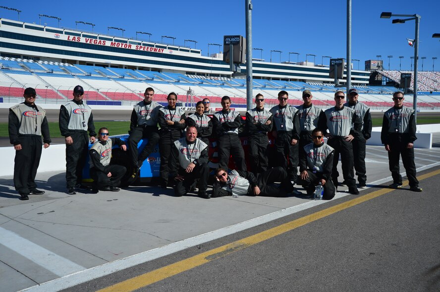 Airmen from Creech and Nellis Air Force Bases pose for a photo during the Richard Petty Driving Experience at the Las Vegas Motor Speedway, Sept. 22, 2013. The event was sponsored by Nellis Outdoor Recreation Single Airmen Incentive Program and like other events it was provided at little or no cost to the participants. (U.S. Air Force photo by Staff Sgt. N.B.)