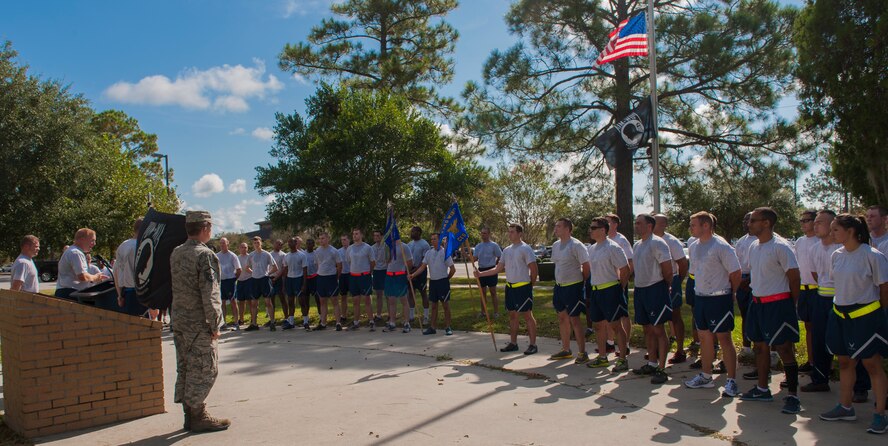 Airmen listen to a short speech at the end of a 23-mile run on Moody Air Force Base, Ga., Sept. 20, 2013. The ceremony was held to to remember those who were and are Prisoners of War or Missing in Action. (U.S. Air Force photo by Airman Alexis Grotz/Released)