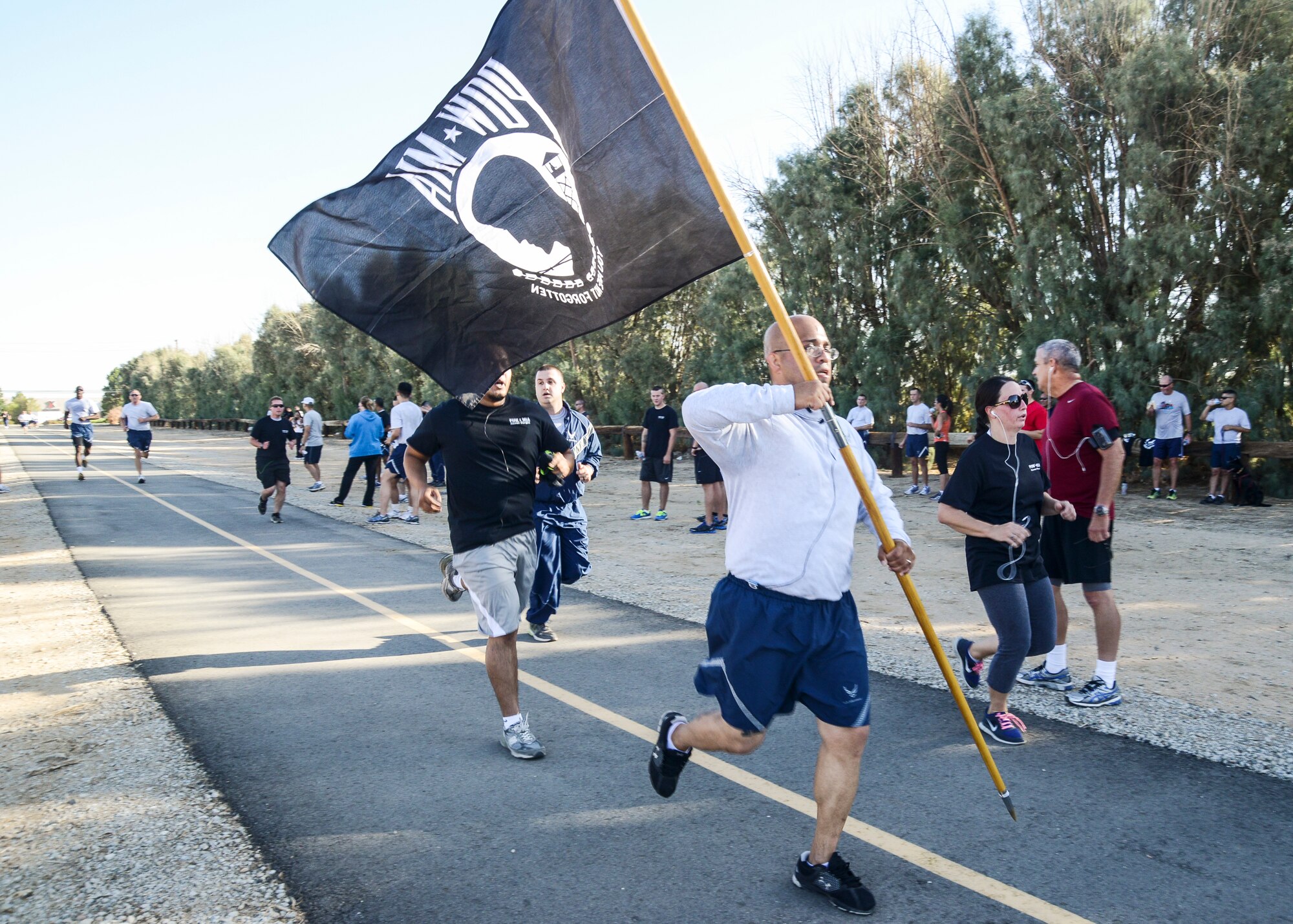 Tech. Sgt. Donald Martinez, 31st Test and Evaluation Squadron, runs with the POW/MIA flag to show his support. The flag was passed between members of his unit throughout the run. (U.S. Air Force photo by Rebecca Amber) 