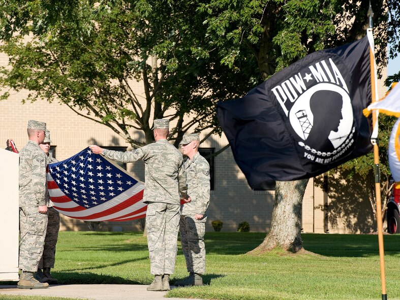 Members of the Dover Air Force Base Honor Guard fold the U.S. flag during a prisoner of war/missing in action ceremony Sept. 20, 2013, at Dover AFB, Del. Team Dover took time to honor those listed as MIA or POW, by participating in a run and vigil Sept. 19 and Sept. 20. (U.S. Air Force photo/Roland Balik)