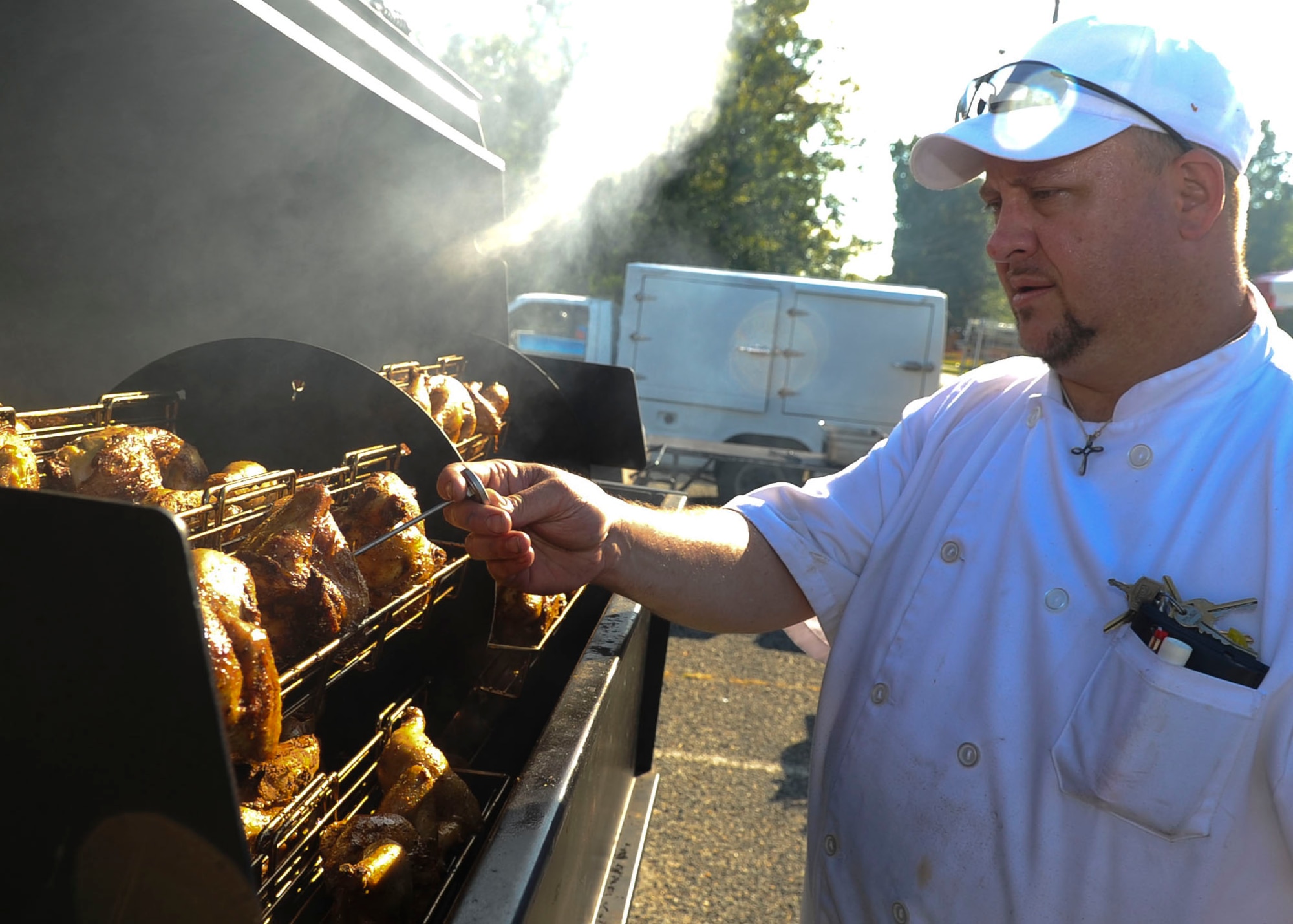 Tim Cooper, Fort Eustis Club executive chef, roasts chickens for Oktoberfest at Fort Eustis, Va., Sept. 20, 2013. Chicken, fried potatoes and vegetable medleys were a few of the dishes served during the Friday evening event. (U.S. Air Force photo by Airman 1st Class Austin Harvill/Released)