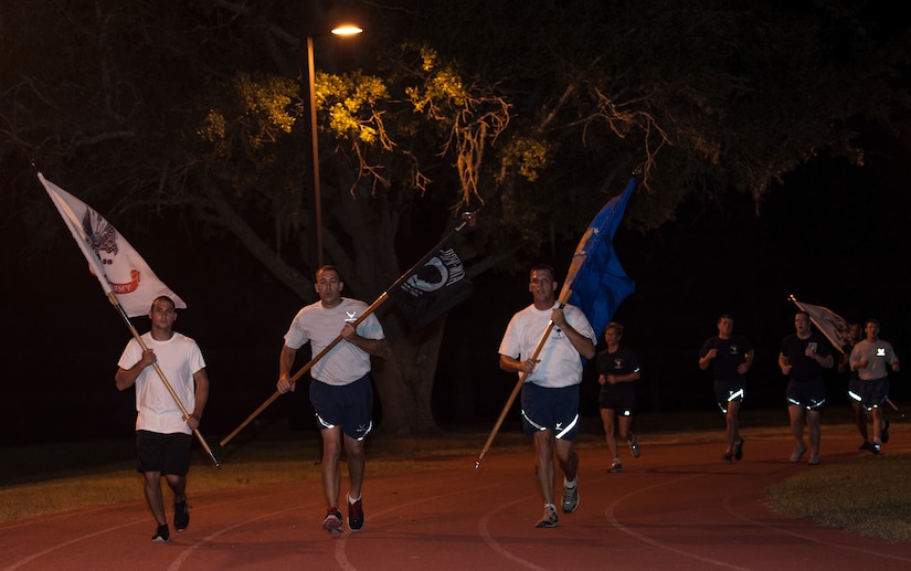 Airmen run during the POW/MIA Run Sept. 20, 2013, at Joint Base Charleston – Air Base, S.C. Different units from the joint base carried the flag in 30-minute increments from 3:30 p.m. Sept. 19 to 3:30 p.m. Sept. 20 in honor of all POWs and MIAs. Over 660 runners participated in the vigil and logged nearly 2,000 miles. (U.S. Air Force photo/ Airman 1st Class Chacarra Neal)