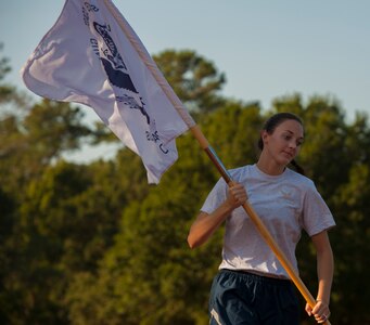 Capt. Rachel Rogalski, 315th Air Expeditionary Squadron flight nurse runs with a flag during the POW/MIA Run Sept. 20, 2013, at Joint Base Charleston – Air Base, S.C. Different units from the joint base carried the flag in 30-minute increments from 3:30 p.m. Sept. 19 to 3:30 p.m. Sept. 20 in honor of all POWs and MIAs. Over 660 runners participated in the vigil and logged nearly 2,000 miles. (U.S. Air Force photo/ Airman 1st Class Chacarra Neal)
