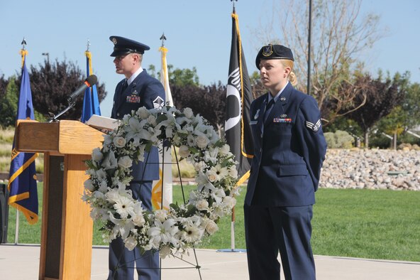 Senior Airman Deanna Harpster, 377th Security Forces Squadron, stands at attention by a wreath at the start of the POW/MIA Recognition Day ceremony Sept. 20 at the New Mexico Veteran's Memorial Park. Several hundred Team Kirtland members attended the event, which honored the sacrifices war veterans made in defense of our country. (Photo by Dennis Carlson)
