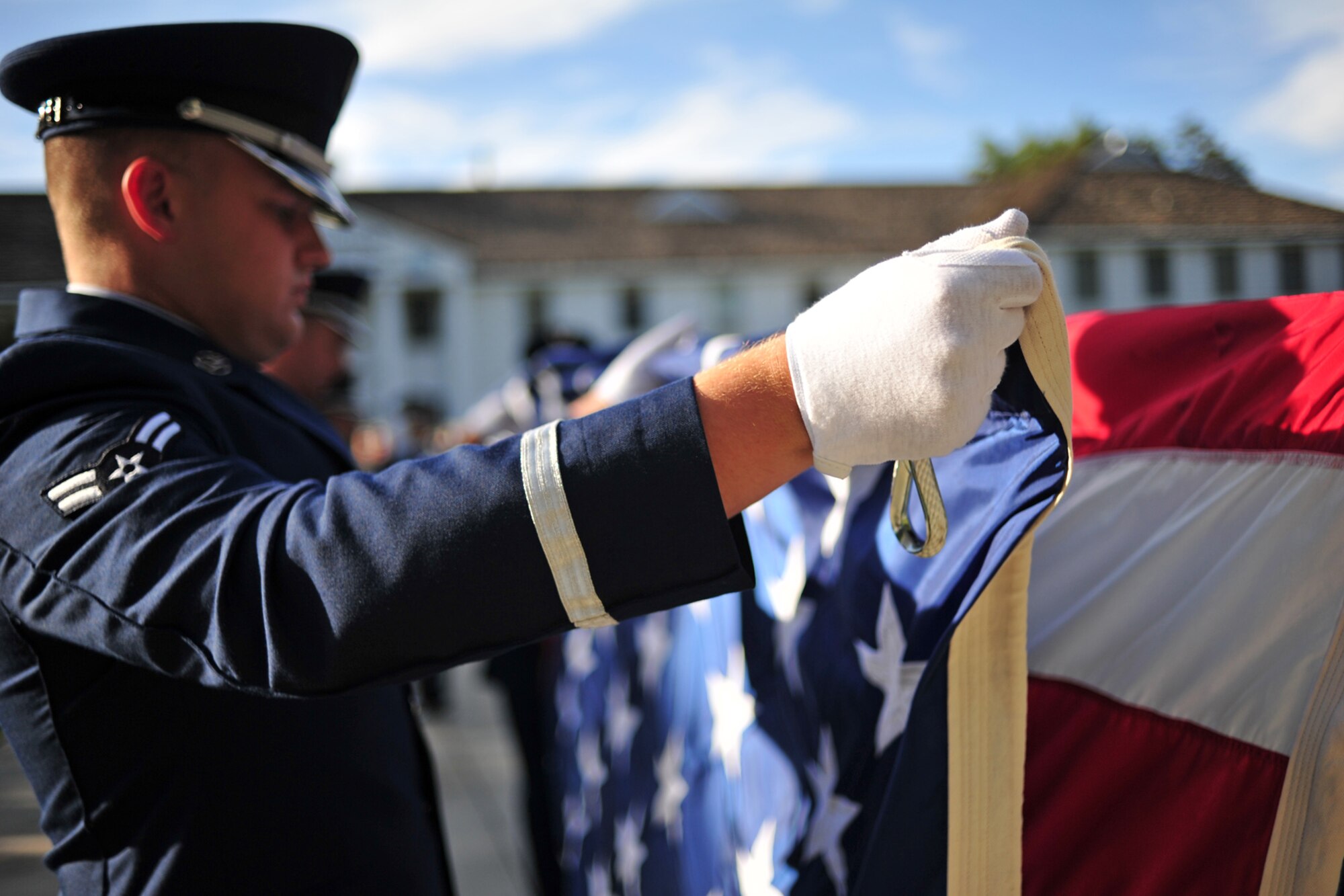 Honor guard members fold the U.S. flag during a POW/MIA Recognition Day Retreat ceremony at Fairchild Air Force Base, Wash., Sept. 20, 2013. (U.S. Air Force photo by Senior Airman Taylor Curry/Released)