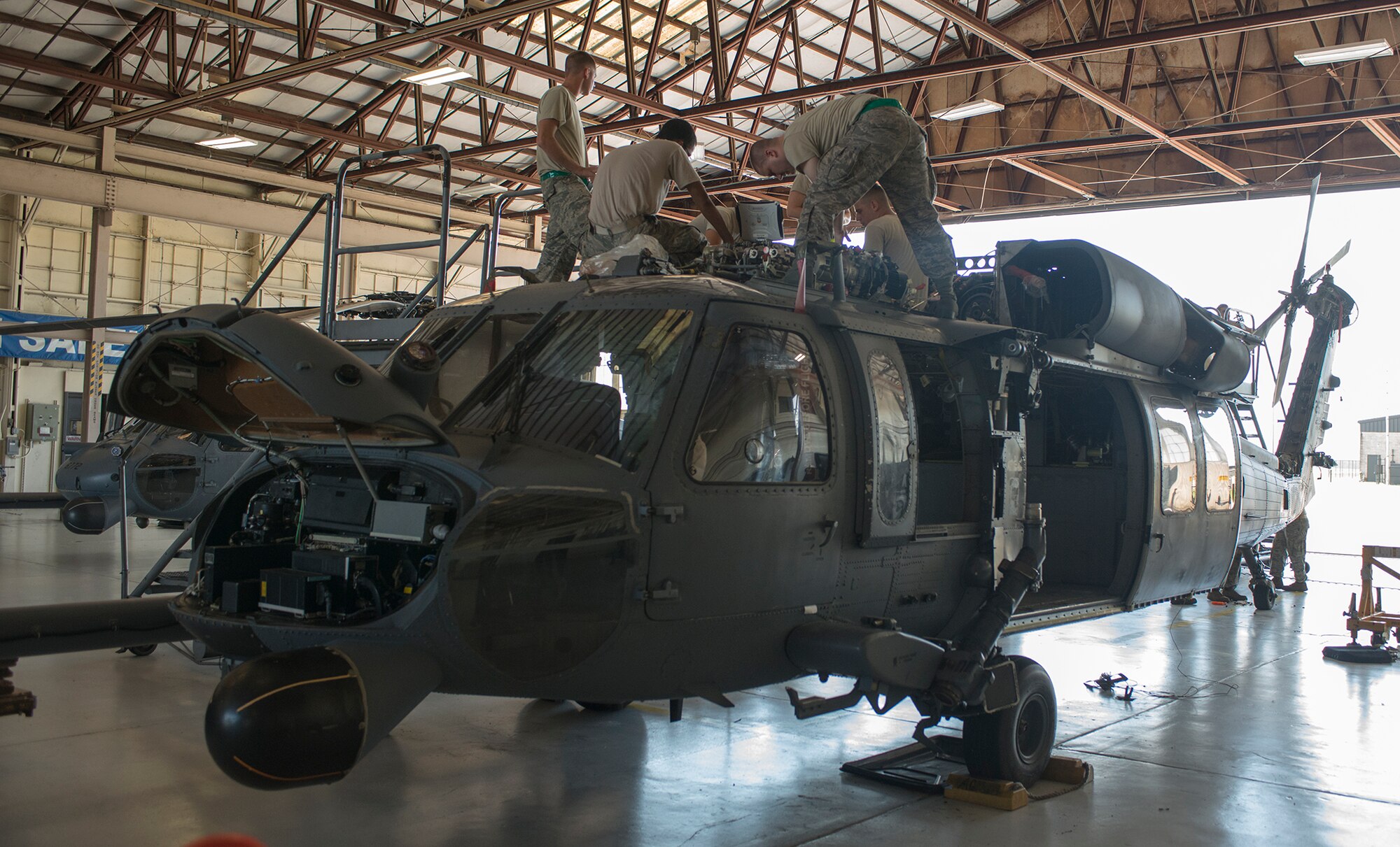 U.S. Air Force Airmen from the 723d Aircraft Maintenance Squadron work on top of an HH-60G Pave Hawk at Moody Air Force Base, Ga., Sept. 16, 2013. The 723d AMXS Airmen inspect and maintain the HH-60G, the HC-130P Combat King and the A-10C Thunderbolt II. (U.S. Air Force photo by Airman 1st Class Ryan Callaghan/Released)
