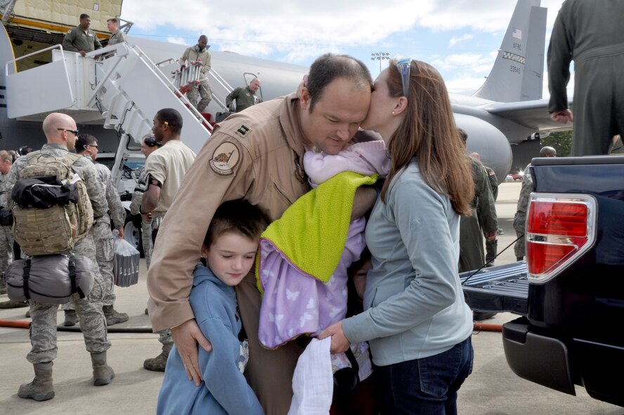 U.S. Air Force Capt. Stephen Akins, pilot at the 459th Air Refueling Wing, is greeted by his family upon his return from an overseas deployment, Joint Base Andrews, Md., September 23, 2013. The 459 ARW were deployed to Southwest Asia in support of Operation Enduring Freedom. (U.S. Air Force photo/ Staff Sgt. Katie Spencer) 