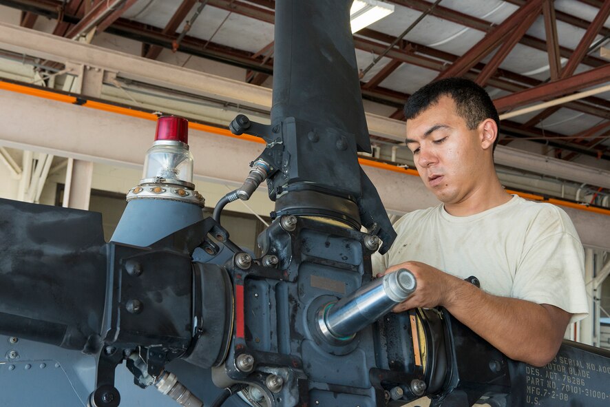 U.S. Air Force Airman 1st Class Jeremy David, 723d Aircraft Maintenance Squadron crew chief, assembles the tail rotor of an HH-60G Pave Hawk at Moody Air Force Base, Ga., Sept. 16, 2013. As a crew chief, David must have a basic knowledge of all the systems of the aircraft and perform general maintenance. (U.S. Air Force photo by Airman 1st Class Ryan Callaghan/Released)
