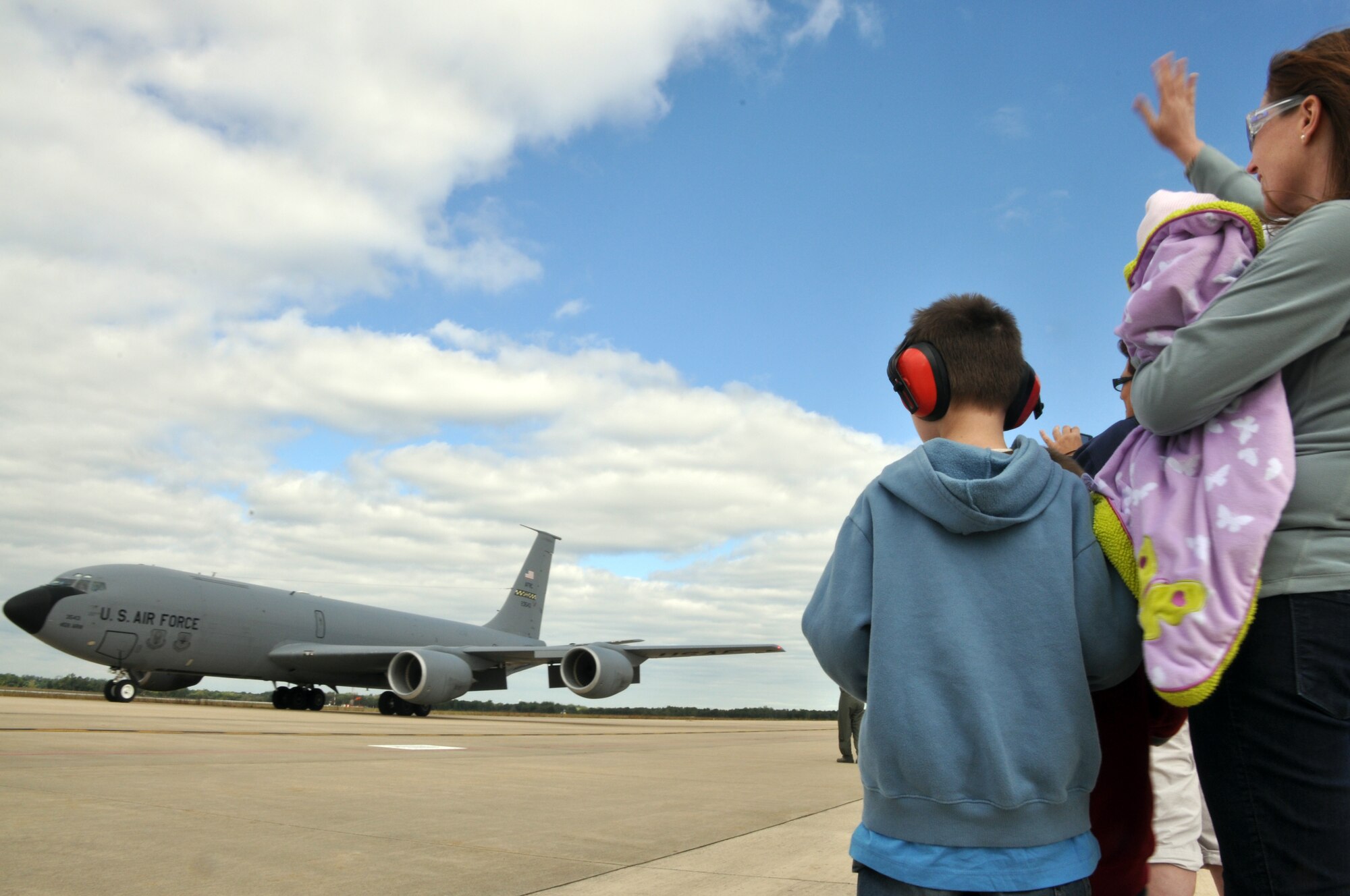 Family members from the 459th Air Refueling Wing, Joint Base Andrews, Md., wave to a KC-135 Stratotanker returning from an overseas deployment, September 23, 2013. The troops were deployed to Southwest Asia in support of Operation Enduring Freedom. (U.S. Air Force photo/ Staff Sgt. Katie Spencer) 