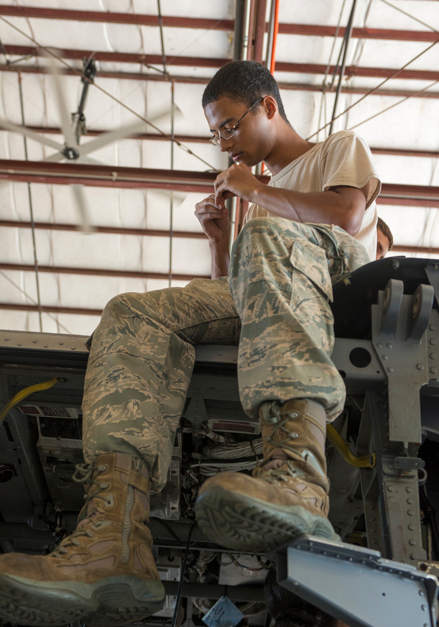 U.S. Air Force Airman 1st Class Phillip Dawson, 723d Aircraft Maintenance Squadron crew chief, inspects a used bolt on top of an HH-60G Pave Hawk at Moody Air Force Base, Ga., Sept. 16, 2013. Airmen clean and inspect removed parts, and if it is deemed to be serviceable, the parts will be reused on the aircraft. (U.S. Air Force photo by Airman 1st Class Ryan Callaghan/Released)
