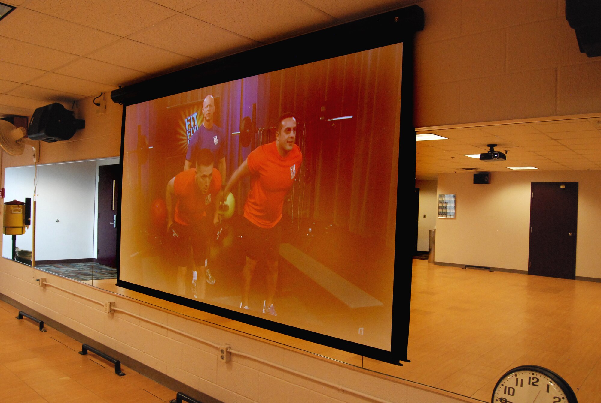 PETERSON AIR FORCE BASE, Colo. – A Fitness on Request kiosk offering cardio, strength training and aerobic workout videos on demand is now available at the Peterson Fitness Center. After selecting a workout routine, the theater comes to life through a ceiling mounted projector, sound system and retractable screen, conveniently putting customizable workout classes on your schedule. (U.S. Air Force photo/Michael Golembesky)