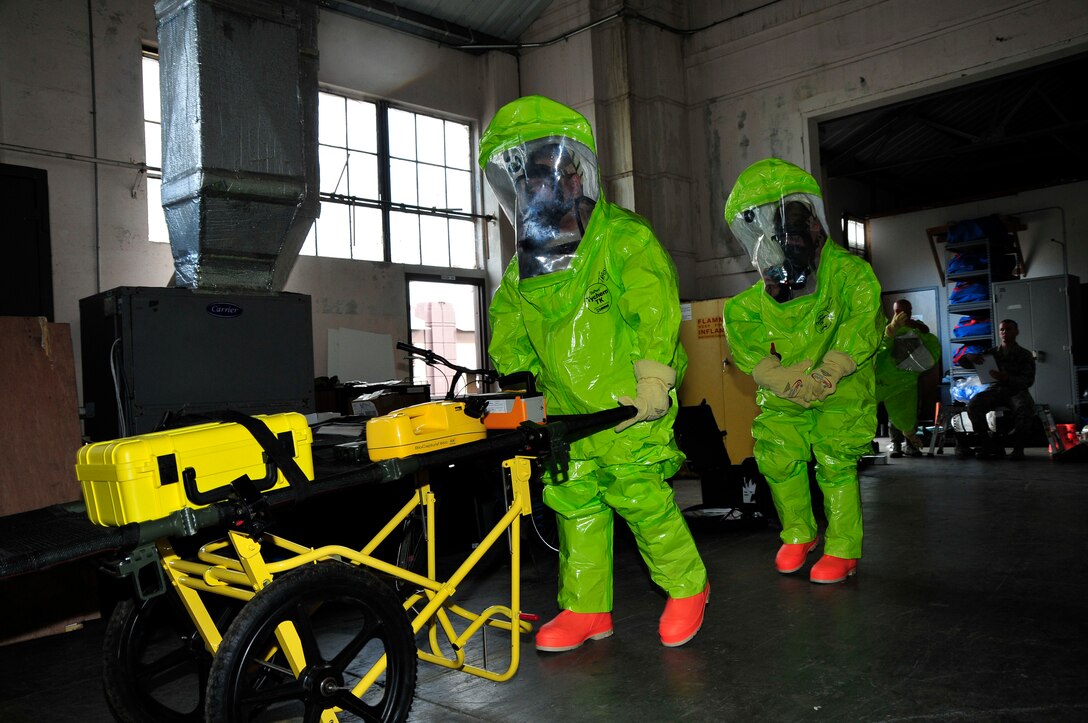 Members of the 134th Air Refueling Wing Civil Engineer Squadron Emergency Management team transport their equipment on site to test for a hazardous substance during a training exercise Joint Base Pearl Harbor- Hickam, Hawaii August 03-17.  (U.S. Air National Guard photo by Master Sgt. Kendra M Owenby/Released)