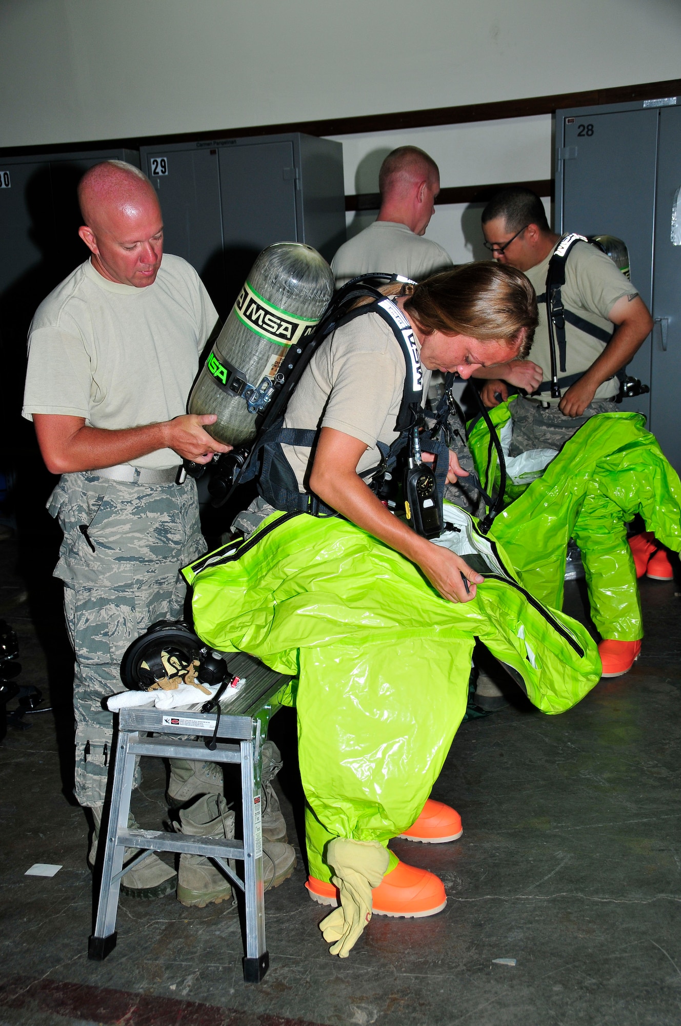 Tech. Sgt. Louis Cunningham adjusts the air tank on a Level A suit for Staff Sgt. Janel Miller during a a training exercise at Joint Base Pearl Harbor- Hickam, Hawaii August 03-17.  Both Tech. Sgt. Cunningham and Staff Sgt. Miller are Emergency Management personnel from McGhee Tyson ANG Base, TN.  (U.S. Air National Guard photo by Master Sgt. Kendra M Owenby/Released)