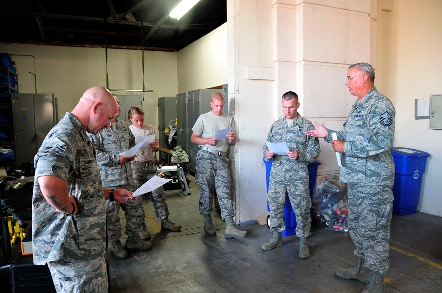 Members of the 134th Air Refueling Wing Civil Engineer Squadron Emergency Management team listen to Master Sgt. Chris King, 134 ARW Emergency Manager,  as he covers the scenario for a training exercise during a deployment to Joint Base Pearl Harbor- Hickam, Hawaii August 03-17.  (U.S. Air National Guard photo by Master Sgt. Kendra M Owenby/Released)