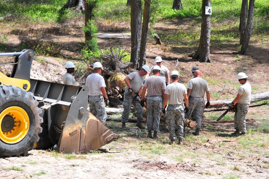 Members of the 134th Air Refueling Wing Civil Engineer Squadron operate heavy equipment to clear away brush from the campground at Bellows Air Force Station, Hawaii during thier Deployed Field Training August 03-17.  (U.S. Air National Guard photo by Master Sgt. Kendra M Owenby/Released)