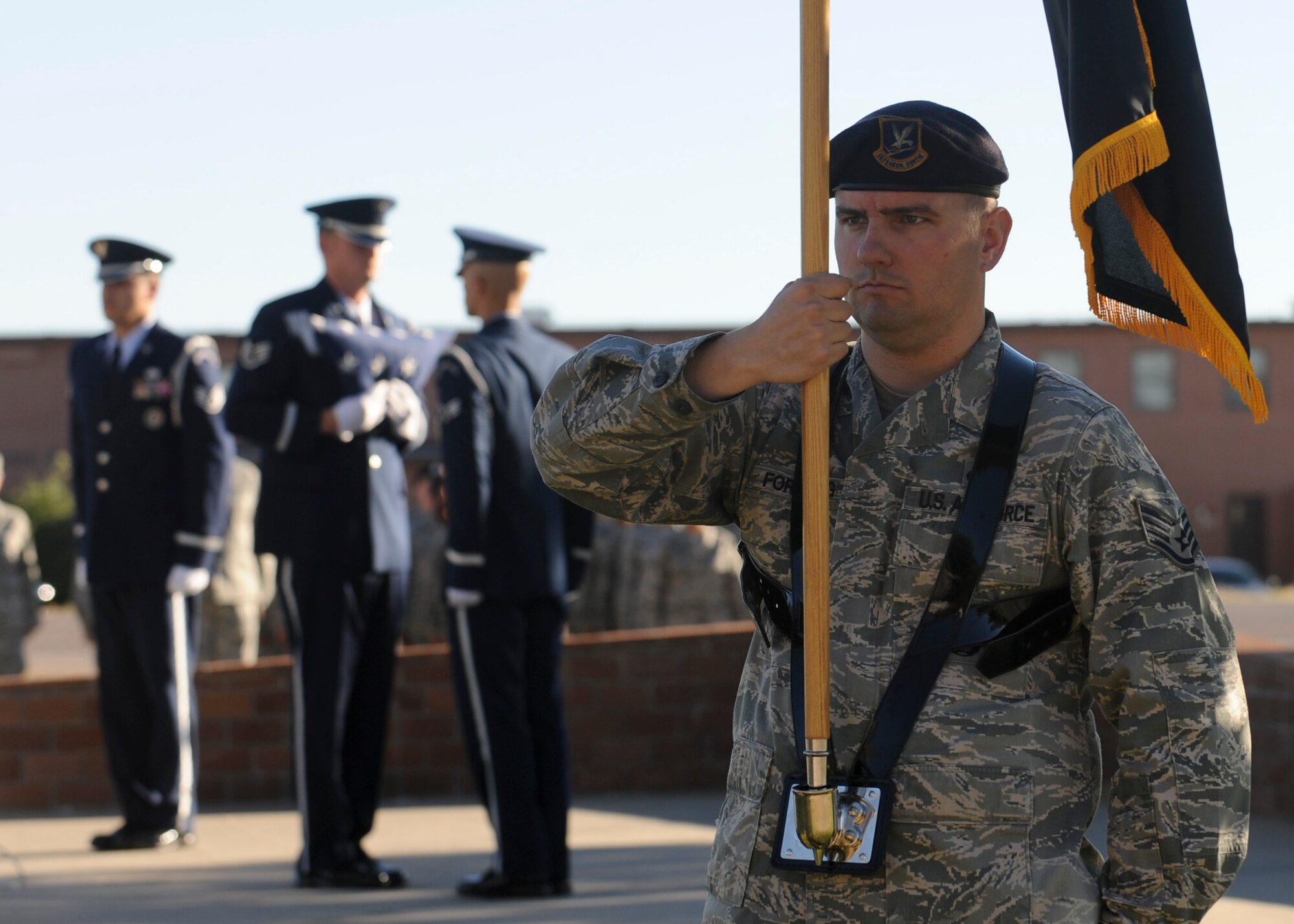 Staff Sgt. Wesley Forsberg, 28th Security Forces Squadron flight sergeant, stands post while holding a POW/MIA flag during a ceremony in front of the 28th Bomb Wing Headquarters at Ellsworth Air Force Base, S.D., Sept. 20, 2013. Several base events were held in conjunction with National POW/MIA Recognition Day including a 5k run and a barbecue. (U.S. Air Force photo by Airman 1st Class Anania Tekurio/Released)