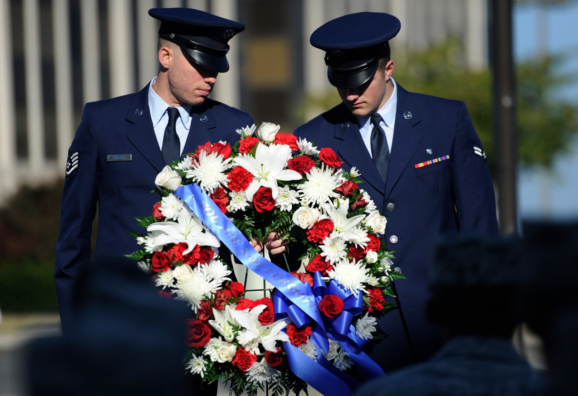 Airmen present a wreath during the POW/MIA Recognition Ceremony at the Airmen Memorial Museum Suitland-Silver Hill, Md., Sept. 20, 2013. The wreath pays tribute to our many fallen comrades who have paid the ultimate sacrifice for our freedom. National POW/MIA Remembrance Day is observed across the nation on the third Friday of September each year in honor of those who were prisoners of war missing in action.  (U.S. Air Force photo/Airman 1st Class Nesha Humes)