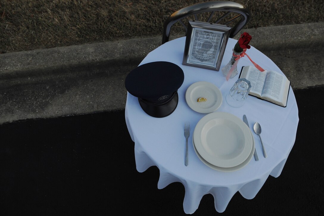 A POW/MIA table sits empty during the POW/MIA Recognition Ceremony at the Airmen Memorial Museum in Suitland-Silver Hill, Md., Sept. 20, 2013. From the red rose to the white linen to the salt upon the plate, all are symbolic in the remembrance of forces missing in action. (U.S. Air Force photo/Airman 1st Class Nesha Humes)