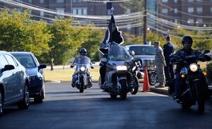 The Green Knights Motorcycle Club drives the POW/MIA flag to present at the Airmen Memorial Museum in Suitland, Md., Sept. 20, 2013.  In honor of National POW/MIA Remembrance Day the Air Force Sergeants Association Chapter 102 held a recognition ceremony near Joint Base Andrews. The Green Knights are a military organized club who work with the Wing Safety Office and Security Forces to help riders retain their rights while following the regulations set forth by the Federal, State, and local bases. (U.S. Air Force photo/Airman 1st Class Nesha Humes)