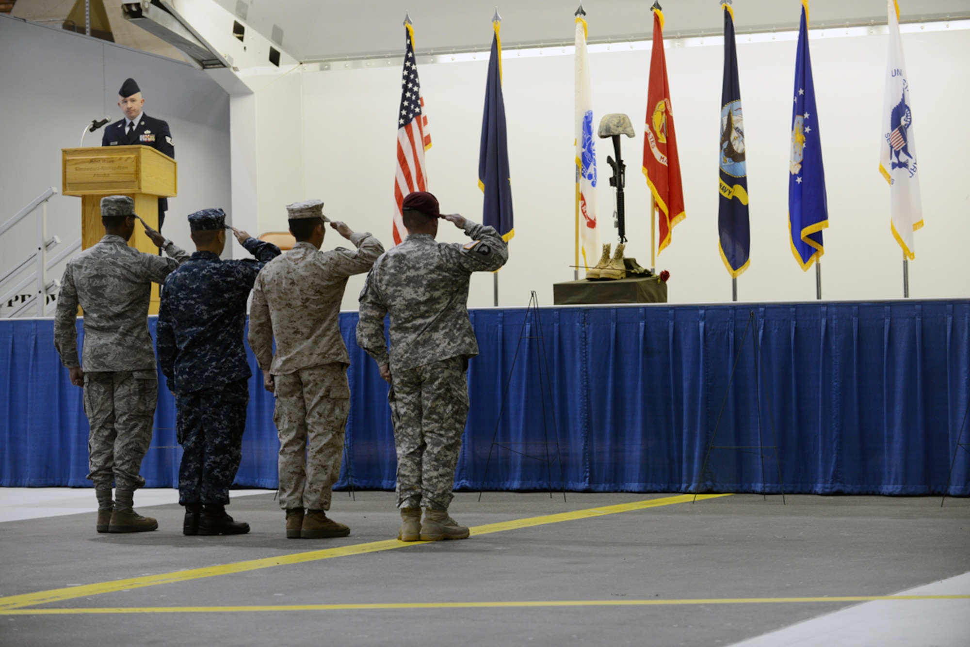 Military members render salutes after placing the helmet, rose, rifle, boots and dog tags to assemble the fallen warrior battle cross commemorating prisoners of war and those missing in action during the POW/MIA recognition day ceremony at Hangar 1 Sept. 20. Arctic Warriors paid tribute to the service members for their sacrifice and those still listed as missing in action. (U.S. Air Force photo/Airman Ty-Rico Lea)