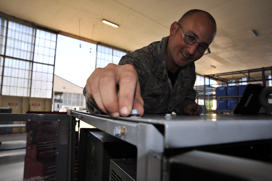 MAXWELL AIR FORCE BASE, Ala. -- Staff Sgt. Joshua Jones, 908th Maintenance Squadron aerospace ground equipment technician, checks that a bolt is securely tightened on an A/M32A-86 generator during a routine maintenance inspection. During these inspections AGE technicians must check the generator’s fluid levels, wiring and hardware to ensure the units can deliver the power needed by the aircraft. (U.S. Air Force photo by Senior Airman Natasha Stannard/Released)