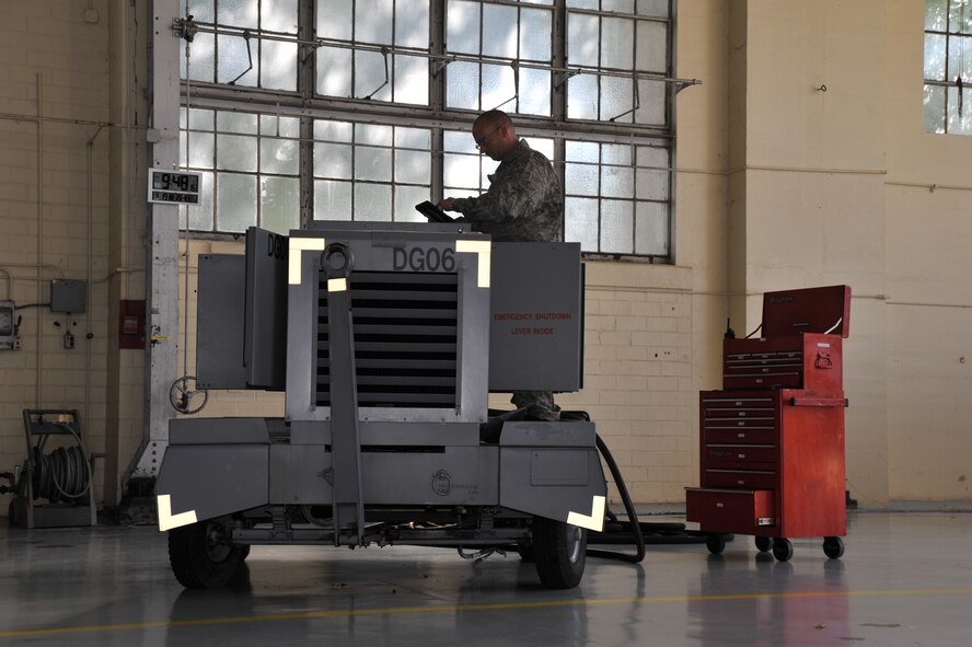 MAXWELL AIR FORCE BASE, Ala. -- Staff Sgt. Joshua Jones, 908th Maintenance Squadron aerospace ground equipment technician, goes through a checklist before conducting routine maintenance on an A/M32A-86 generator Sept. 19, 2013, here. The generator is used to simulate aircraft operating power using more fuel efficient sources. (U.S. Air Force photo by Senior Airman Natasha Stannard/Released)