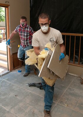 Airman 1st Class Donald Neal, 90th Civil Engineer Squadron structure shop, helps carry damaged plaster board and installation from Deedra Moats’ home in Longmont, Colo., Sept. 21, 2013. Neal helped Jamie McVaney, a mold mitigation expert, work to minimize the damage to the residence after it was swamped by flood waters. Neal was one of several F.E. Warren Air Force Base, Wyo., Airmen who volunteered in relief efforts for the flood-ravaged northern Colorado town. (U.S. Air Force photo by R.J. Oriez)