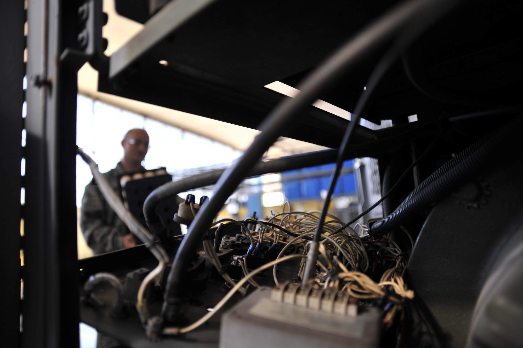 MAXWELL AIR FORCE BASE, Ala. -- Wires protrude from an A/M32A-86 Generator as Staff Sgt. Joshua Jones makes repairs to the piece of equipment Sept. 19, 2013, here. Jones is an aerospace ground equipment technician with the 908th Maintenance Squadron under the 908th Air Lift Wing. The 908th is one of three commands based out of Maxwell. The squadron performs routine maintenance on these generators to ensure they can support the 908th’s air-lift mission. (U.S. Air Force photo by Senior Airman Natasha Stannard/Released) 