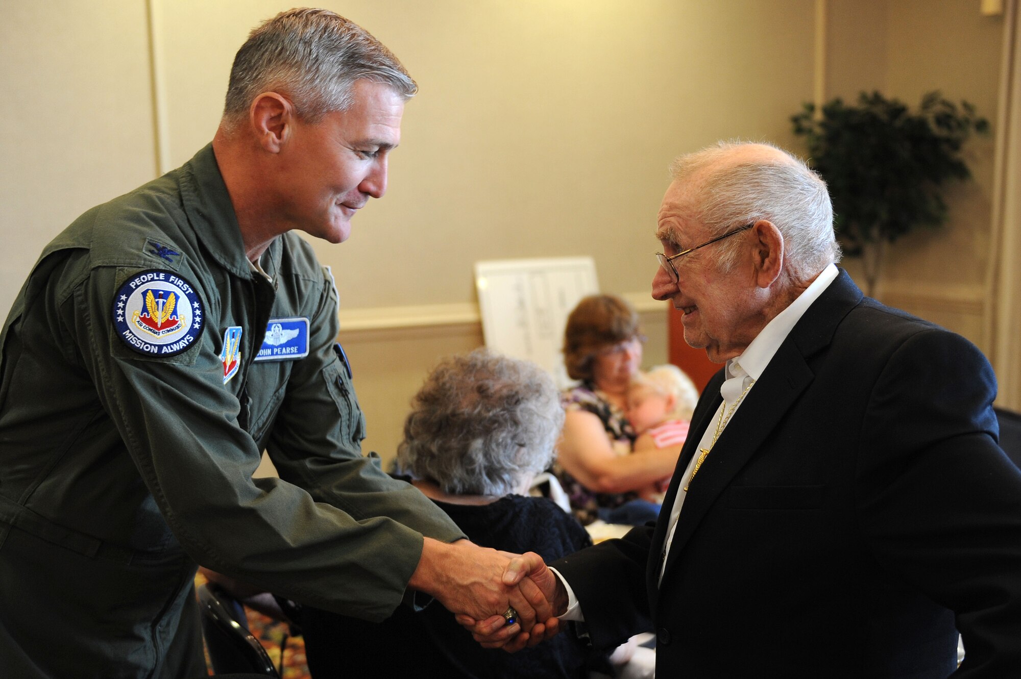 U.S. Air Force Col. John Pearse, Air Combat Command director of staff, greets retired U.S. Army Staff Sgt. Daniel Fenton during the POW/MIA Luncheon at Langley Air Force Base, Va., Sept. 20, 2013. Fenton, a Korean War veteran, was captured on April 25, 1951 and was held for more than two years. (U.S. Air Force photo by Senior Airman Brittany Paerschke-O’Brien/Released)