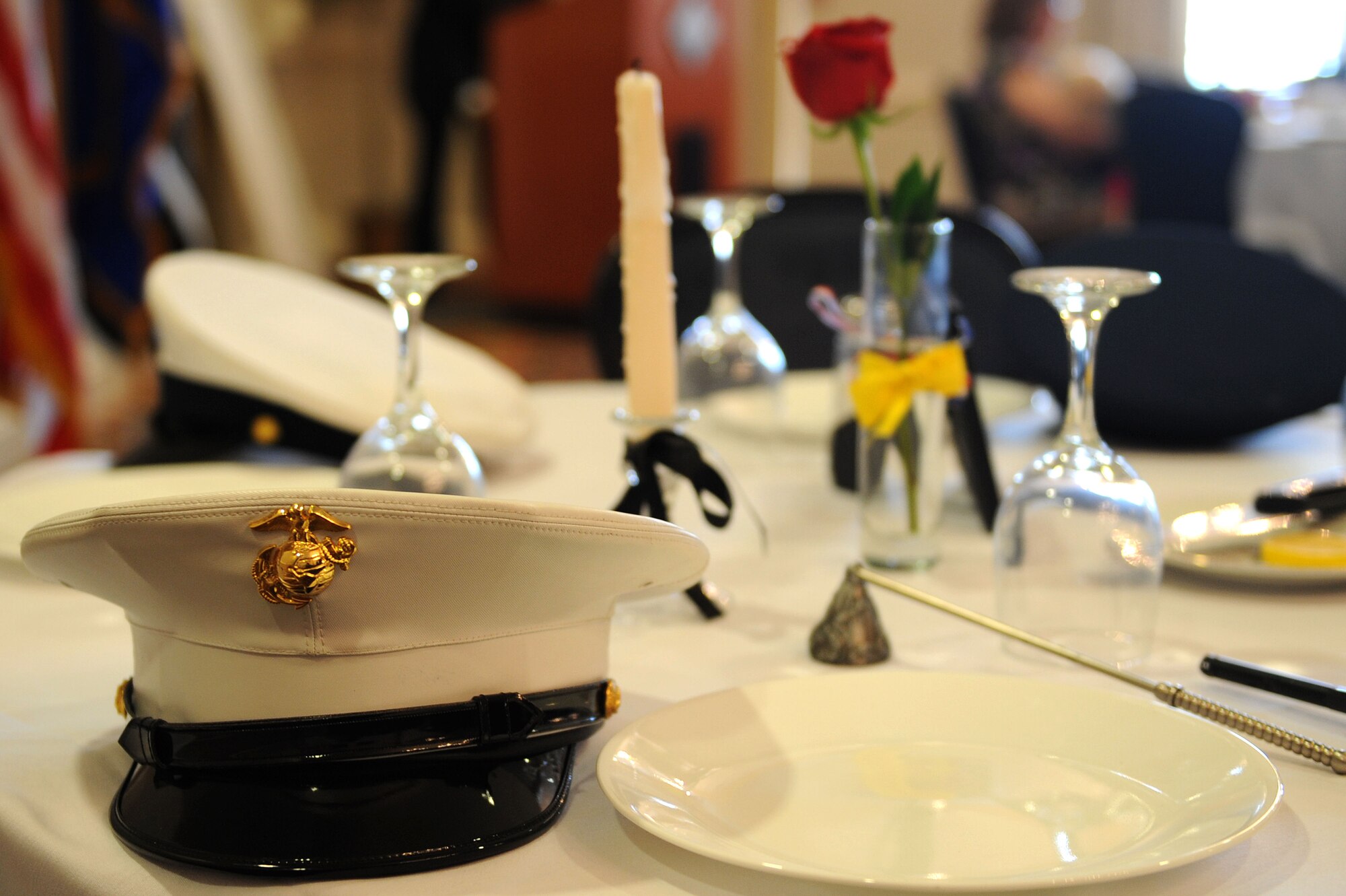 A ceremonial table was arranged with a formal dress hat from the four military services during the POW/MIA Luncheon at Langley Air Force Base, Va., Sept. 20, 2013. The lunch was held in remembrance of POW/MIA military members from all branches of service. (U.S. Air Force photo by Senior Airman Brittany Paerschke-O’Brien/Released)